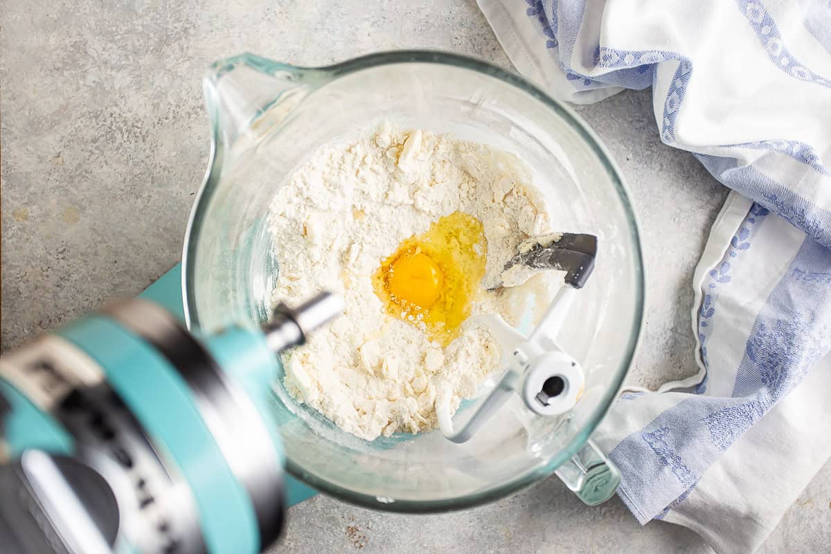 Adding an egg to dry ingredients and butter.