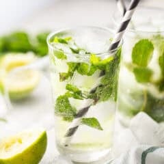 Mojito in a tall, clear glass with lots of fresh mint.