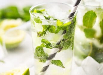Mojito in a tall, clear glass with lots of fresh mint.