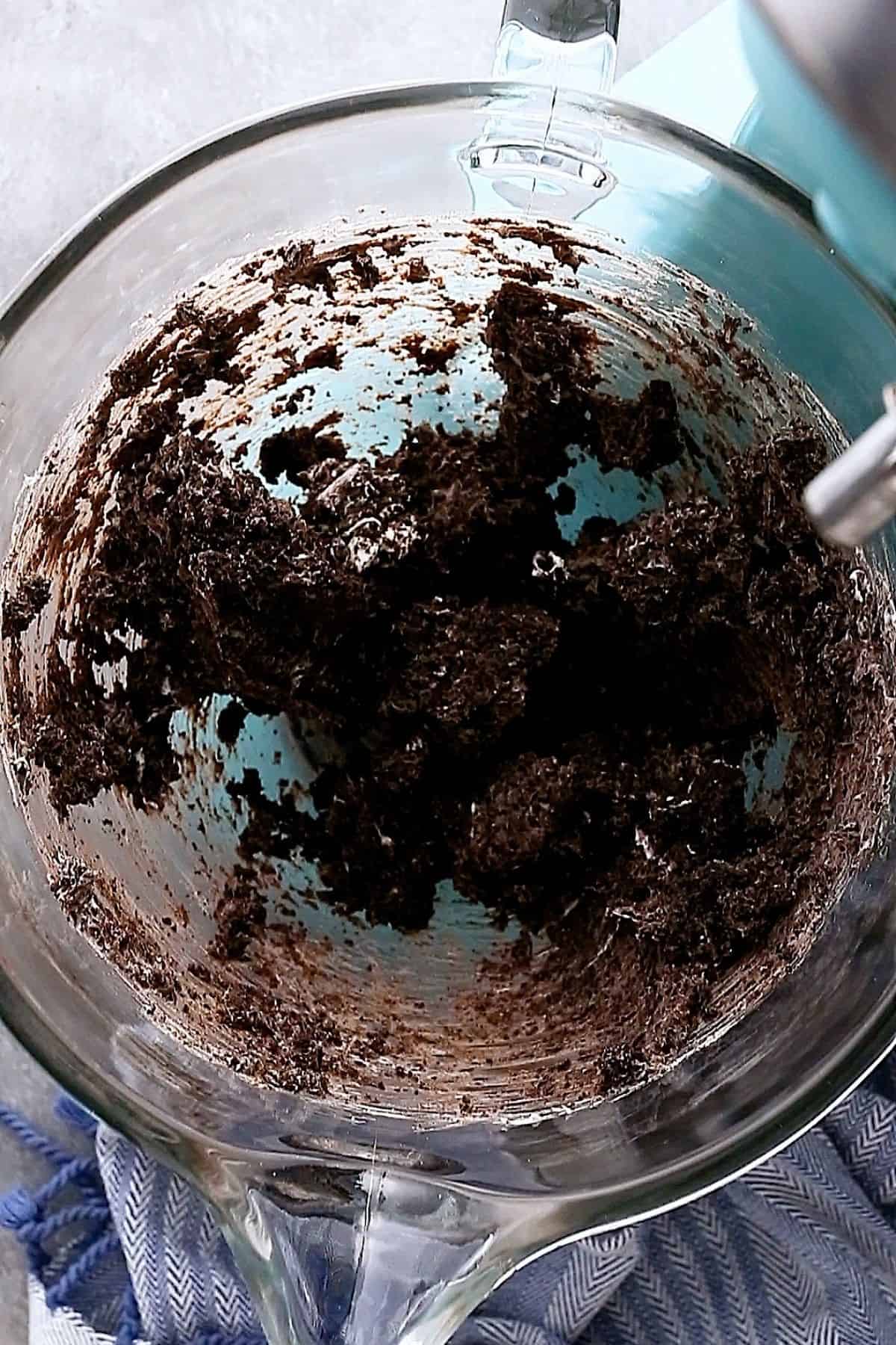 oreo balls dough mixture in the bowl of a stand mixer.