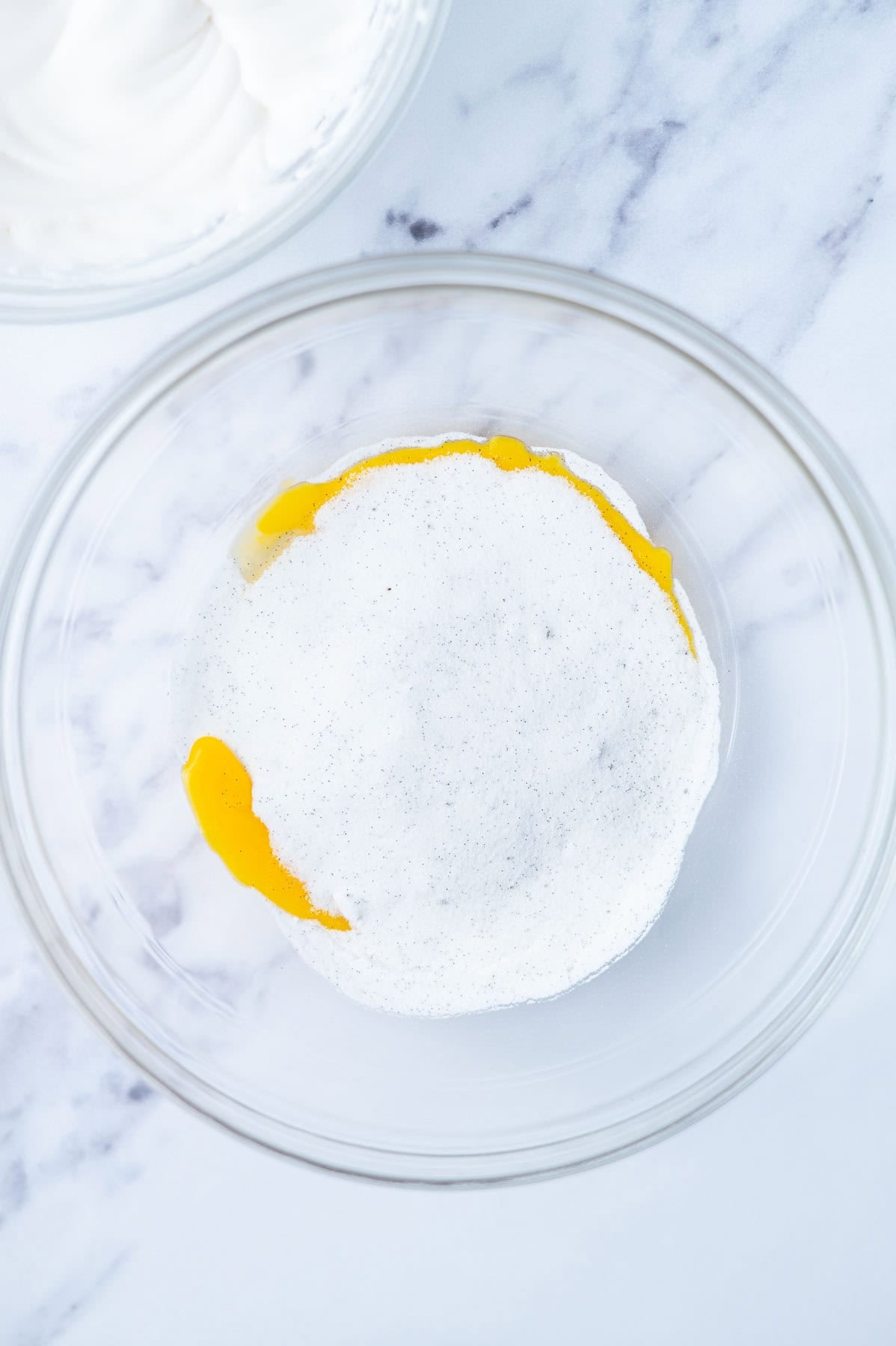 egg yolks and vanilla sugar in a glass mixing bowl