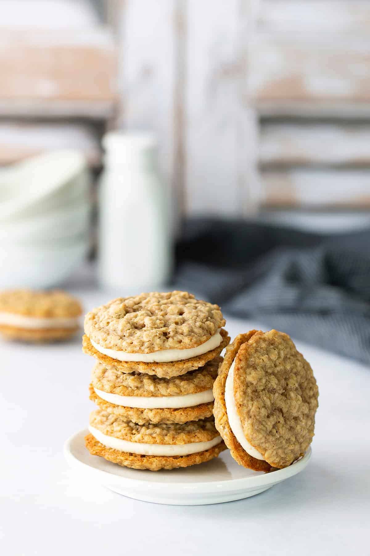 Oatmeal cream pies stacked up on a plate.