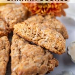 banana scones with a banana icing on parchment paper with fresh flower and ripe bananas in the background with text overlay
