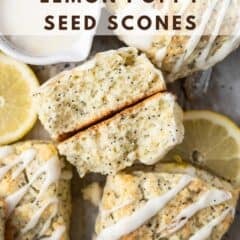 lemon poppy seed scones with one broken in half showing tender inside and fresh lemon slices