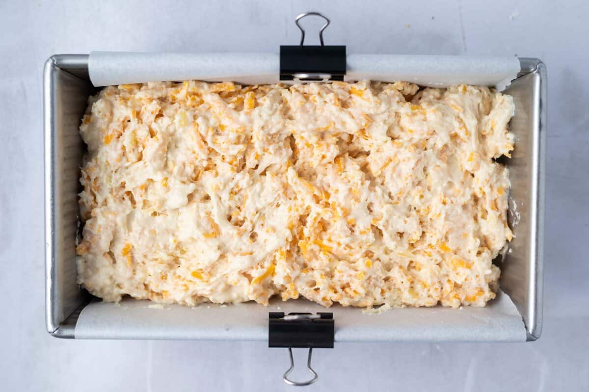 quick bread batter in a parchment lined loaf pan