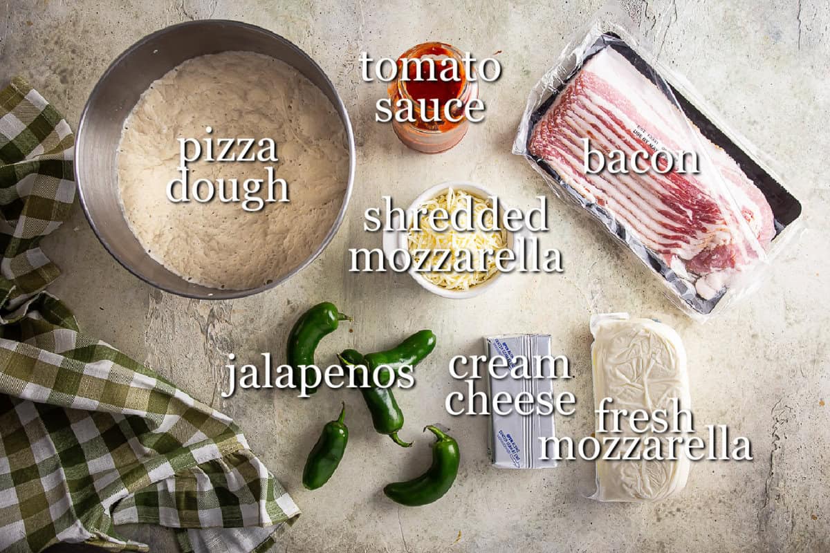 Ingredients for jalapeno popper pizza in separate containers on a gray background.