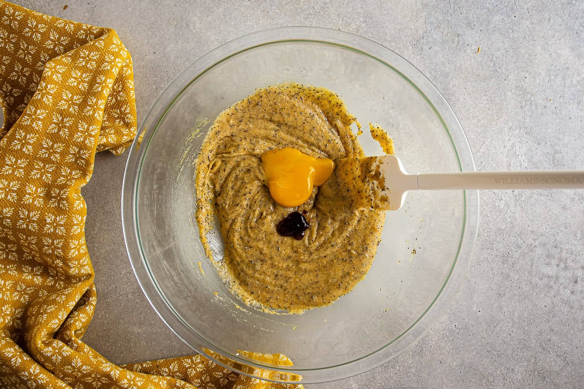 additional egg yolk being added to earl grey cookie dough.