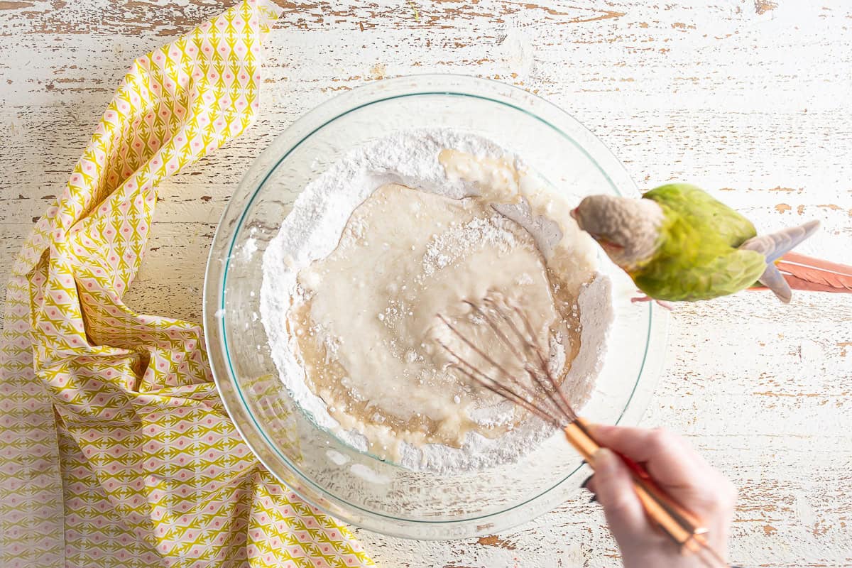 Mixing the strawberry matcha loaf batter with a whisk.