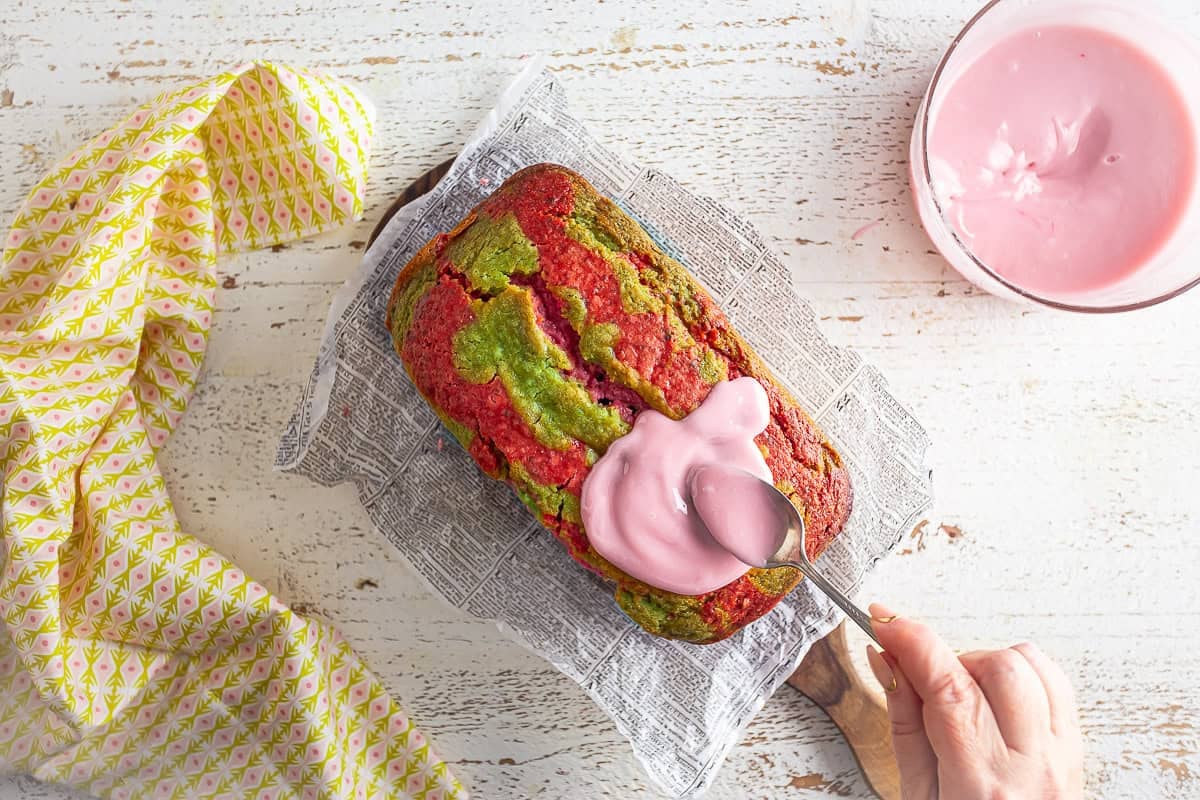 Icing a strawberry matcha loaf.