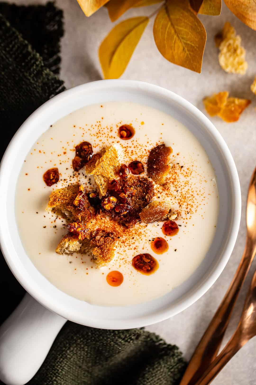 A bowl of cream of cauliflower soup with garnish.