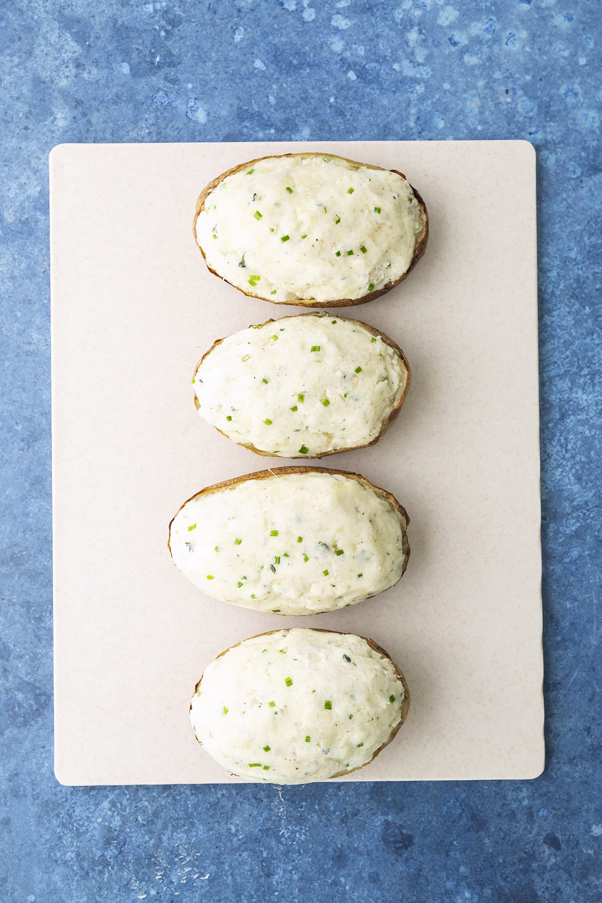 Ingredients stuffed back into potato halves