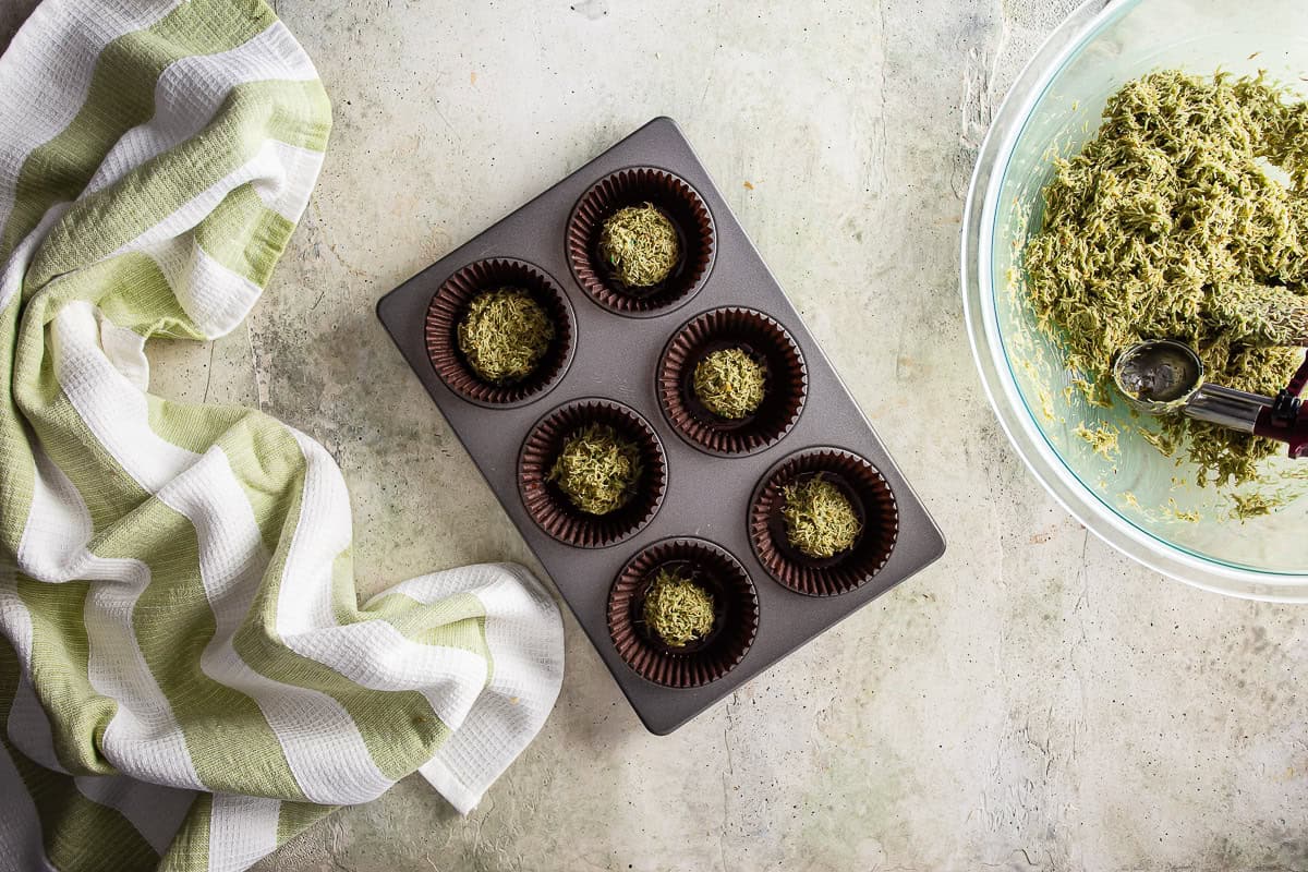 Adding filling to the chocolate bottoms of Dubai chocolate.