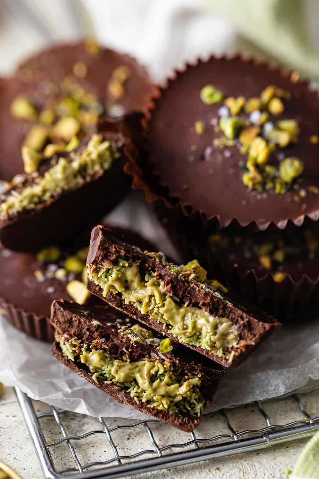 Dubai chocolate with one cut in half and pistachios on top.