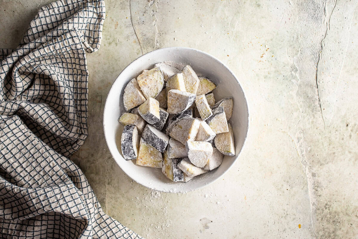 Seasoned eggplant after being dusted with flour.