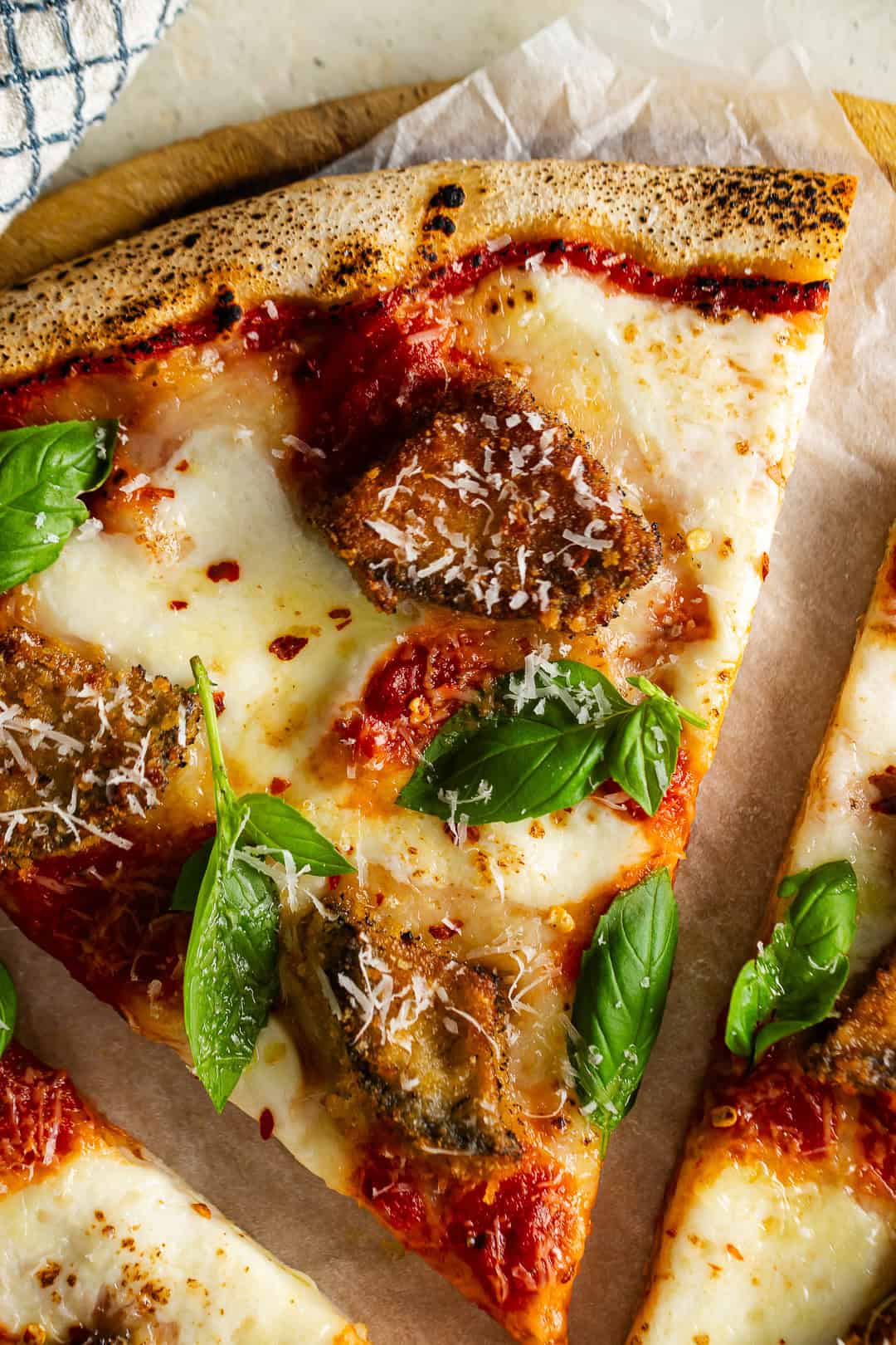 Close up photo of eggplant parmesan pizza.