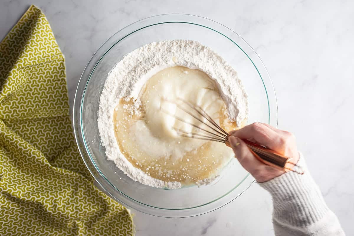 Whisking wet ingredients into the dry for a chocolate pistachio loaf.