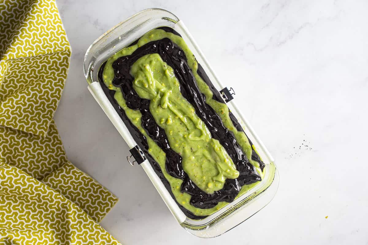 Batter for chocolate pistachio loaf in a prepared pan before being baked.