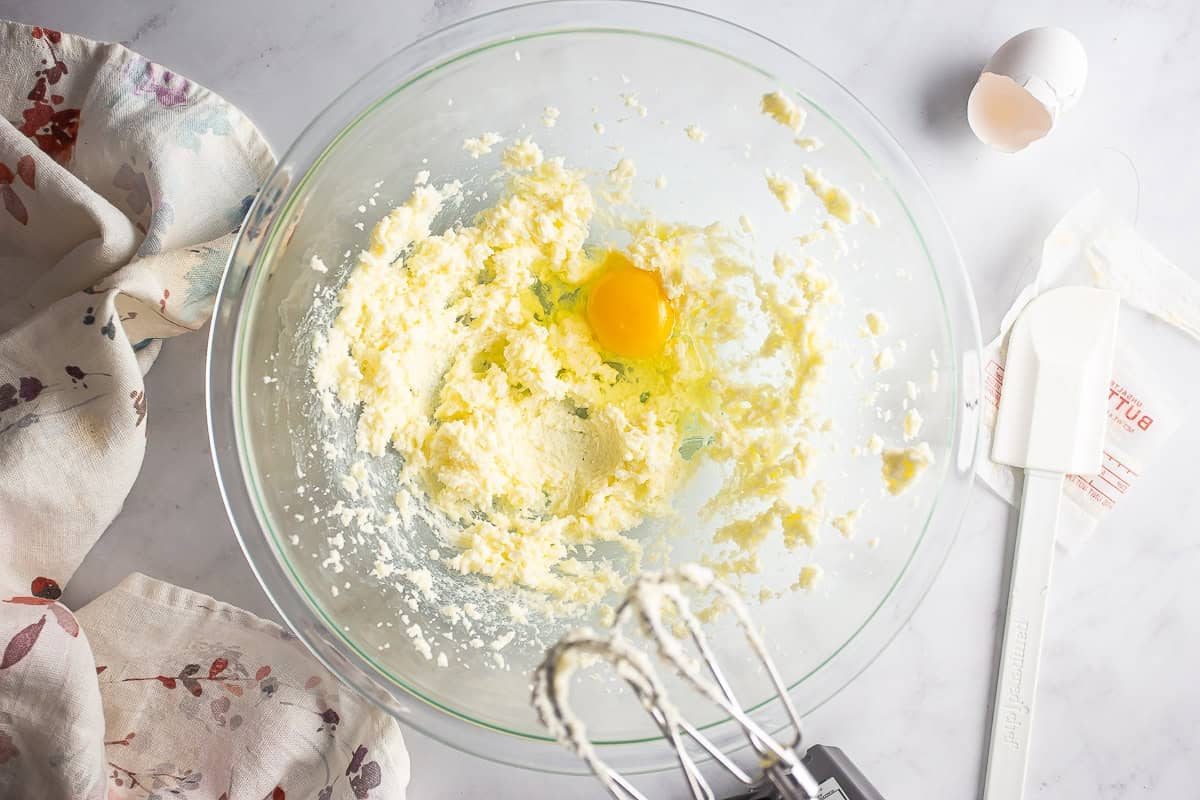 Adding the first egg to the almond roll filling.