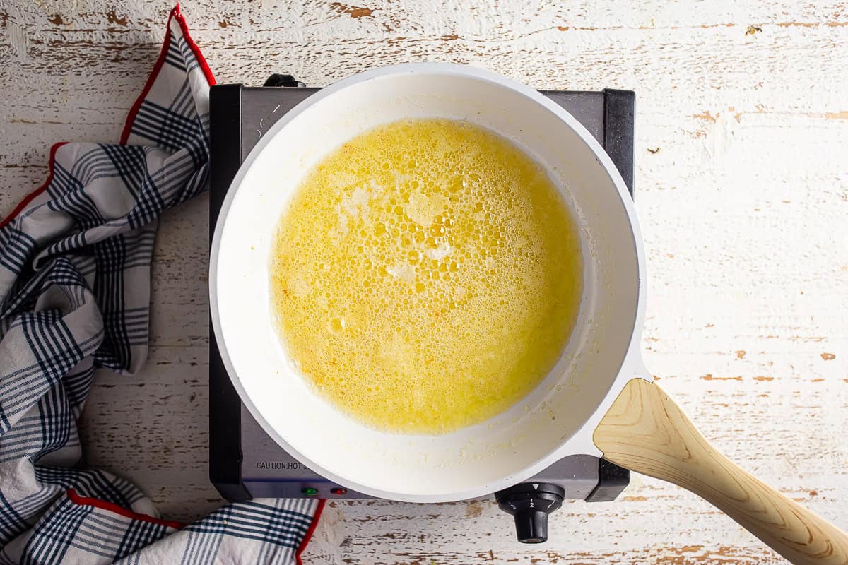 Butter melted in a pan on a burner for browned butter.