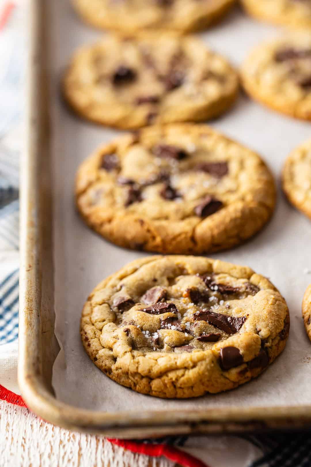 Brown Butter chocolate chip cookies on a prepared baking sheet.