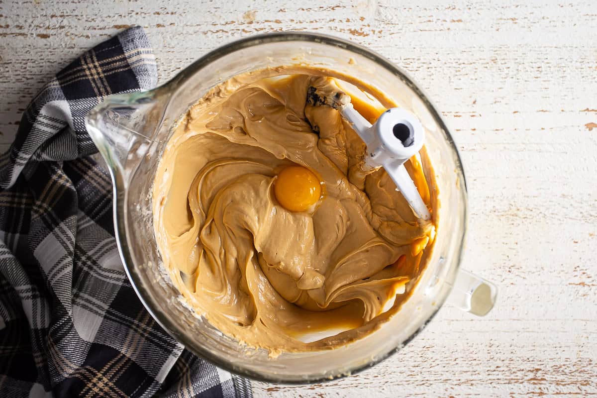 Last egg being added to the Biscoff cheesecake batter.