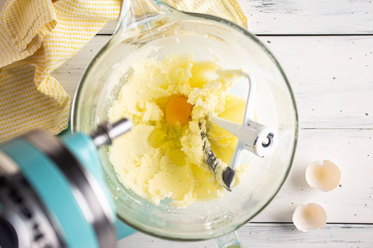 Adding the first egg to lemon butter and sugar.