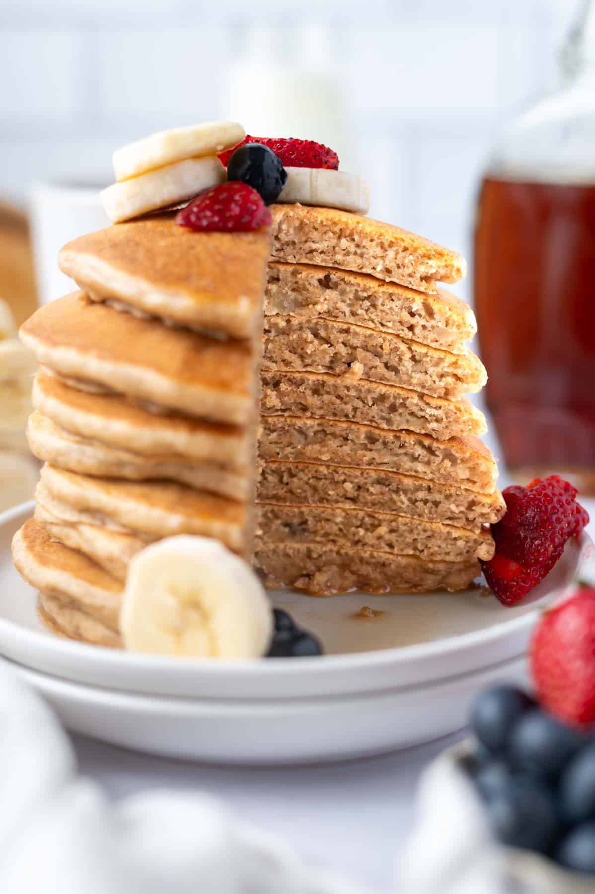 stack of banana pancakes cut to show soft, fluffy inside texture