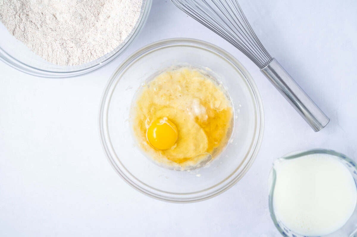 mashed banana, egg and vanilla in a glass bowl