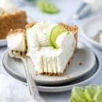 slice of cheesecake on a plate with a bite of it on a fork