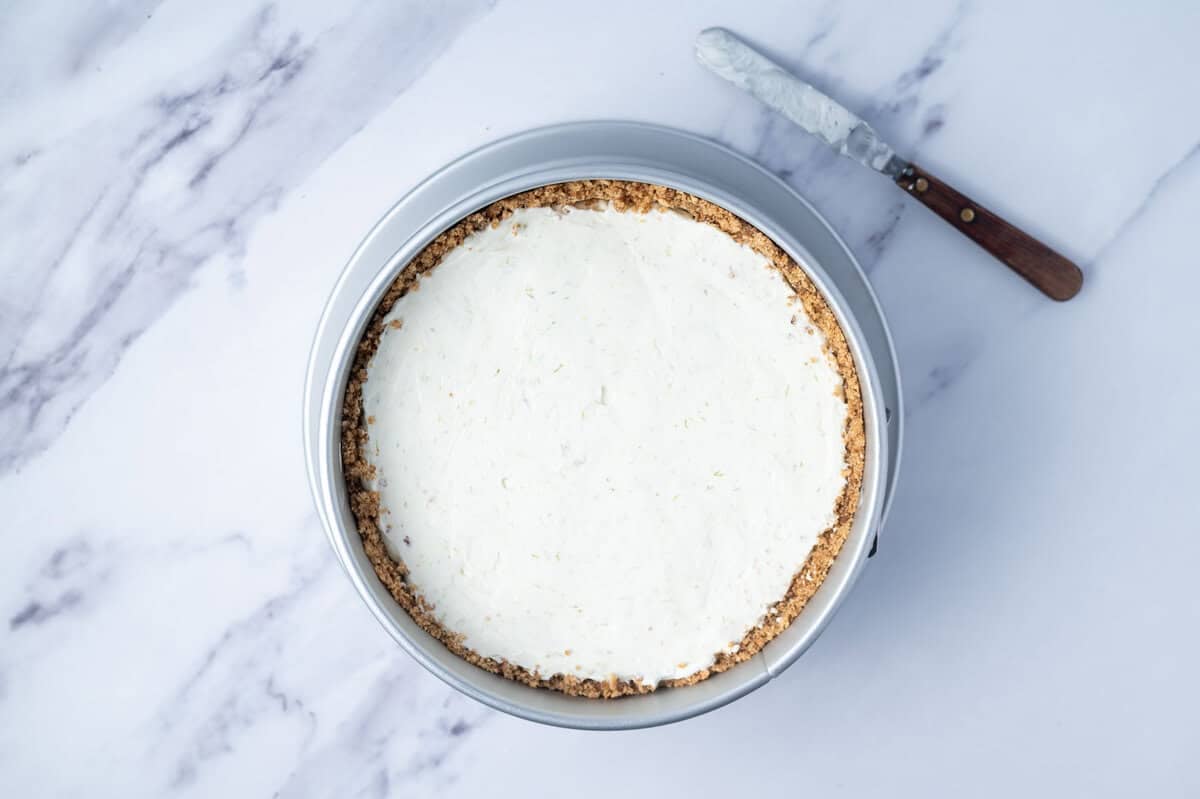 cheesecake filling smoothed into graham cracker crust