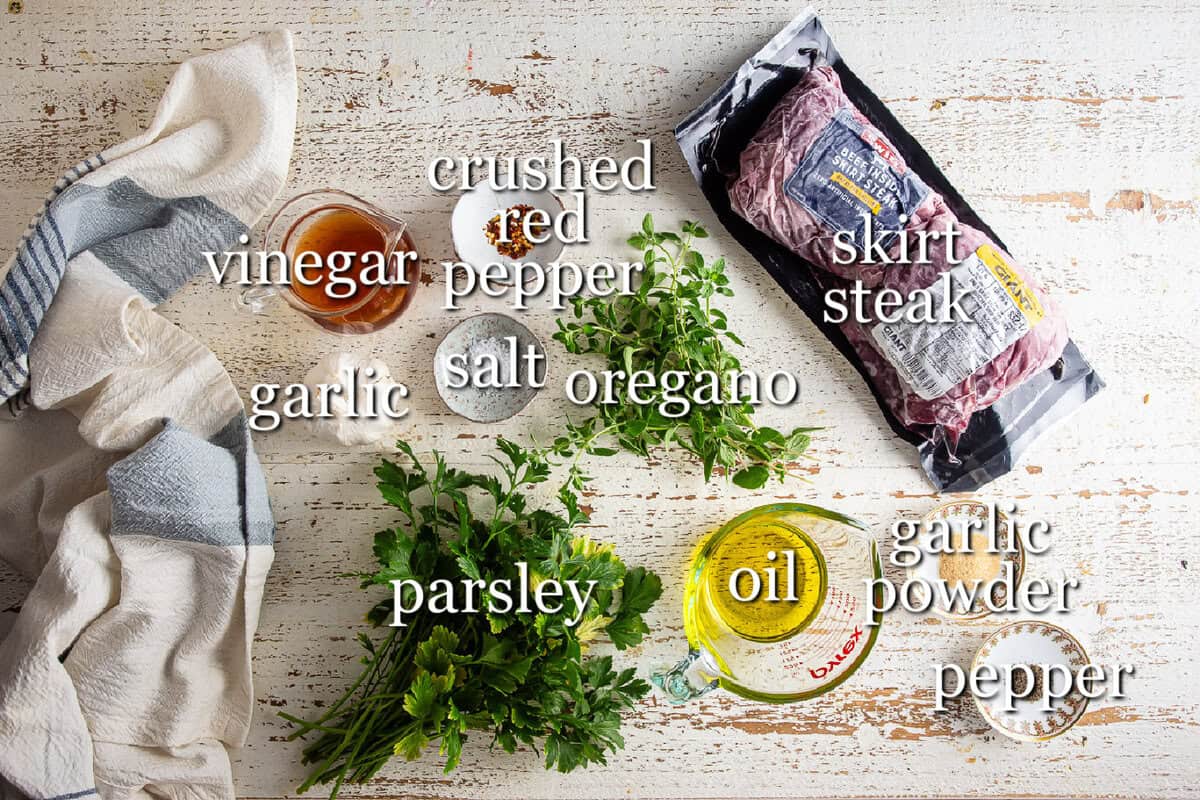Ingredients for chimichurri steak in separate containers.