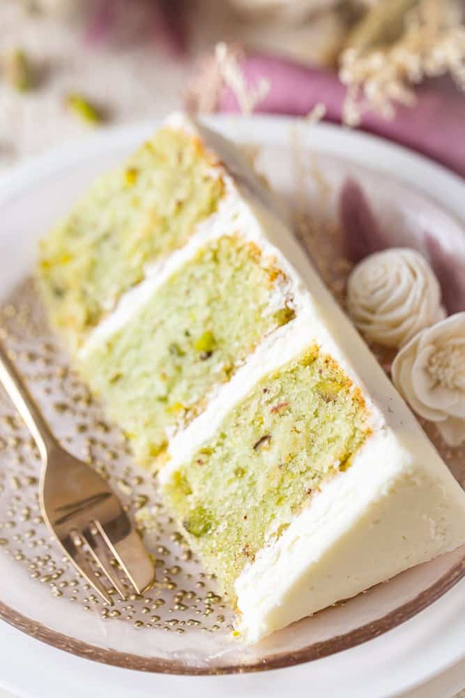 A slice of pistachio cake on a plate.