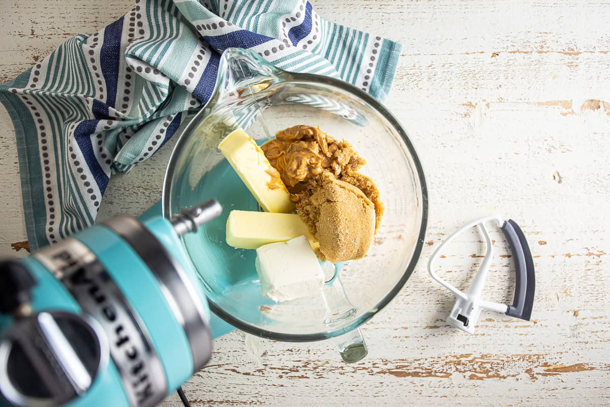 Butter, cream cheese, and brown sugar in a mixing bowl for peanut butter cut-out cookies