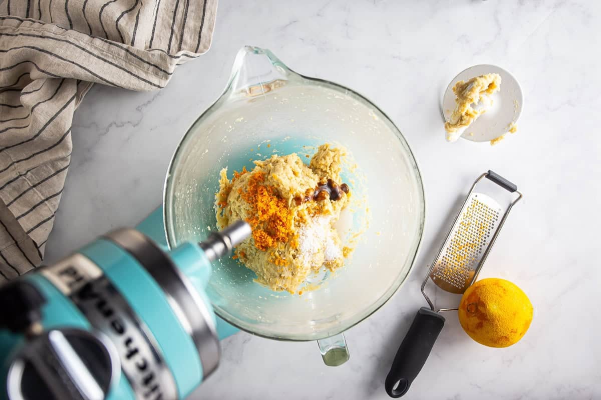Adding orange zest, vanilla, and salt to the maritozzi dough.