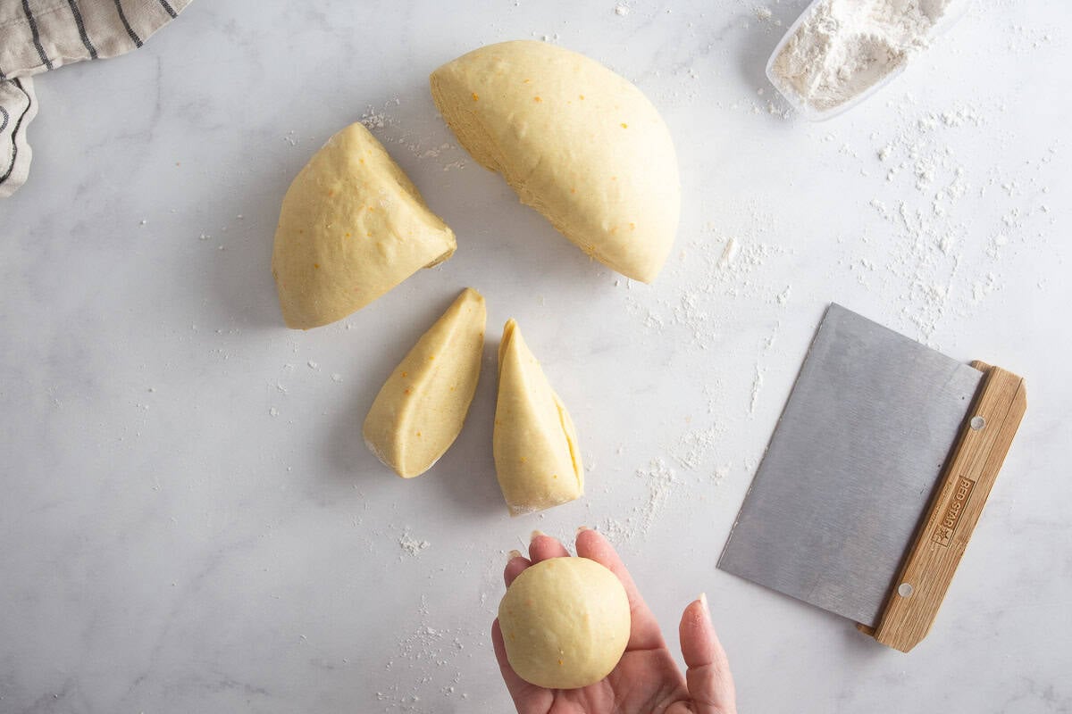 Shaping maritozzi doug into smaller dough balls.
