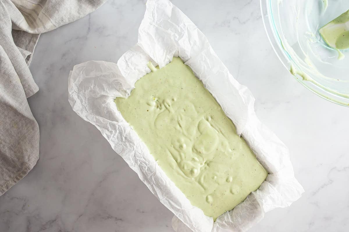 Unfrozen pistachio ice cream base in a rectangle-shaped container