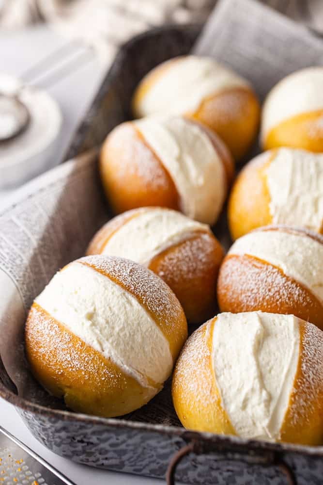 Maritozzi in a large dish with the cream filling showing.