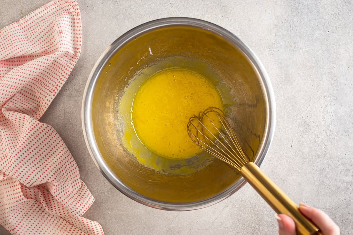 Uncooked egg yoks in a metal bowl.