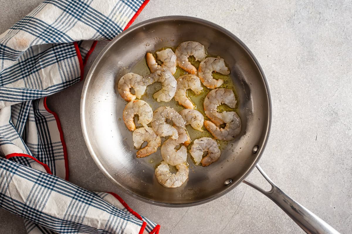 Shrimp searing in a stainless steel pan