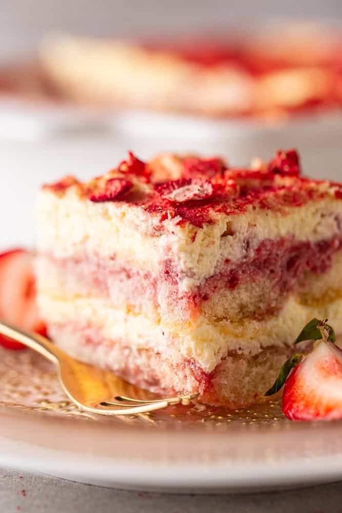 Strawberry tiramisu slice with a gold fork.