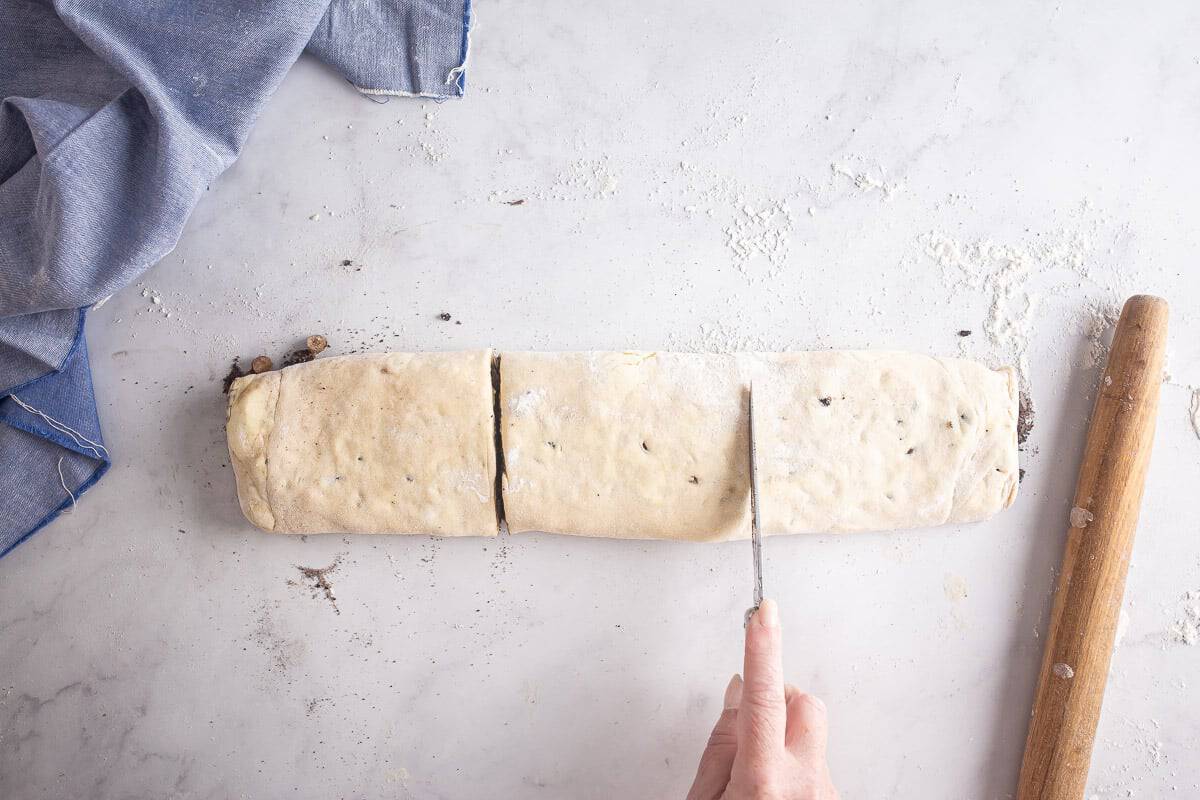 Cutting rolled cookie croissant pastry into portions
