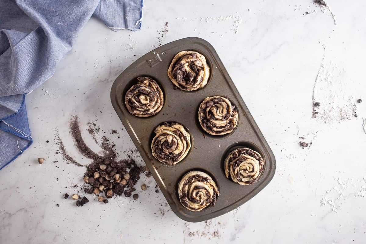 Unbaked cookie croissant swirls in a muffin tin