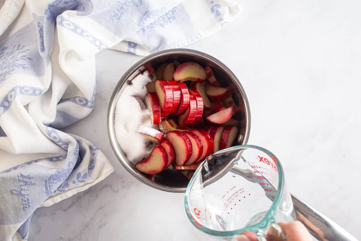 Rhubarb, sugar, and water in a saucepan before being cooked.