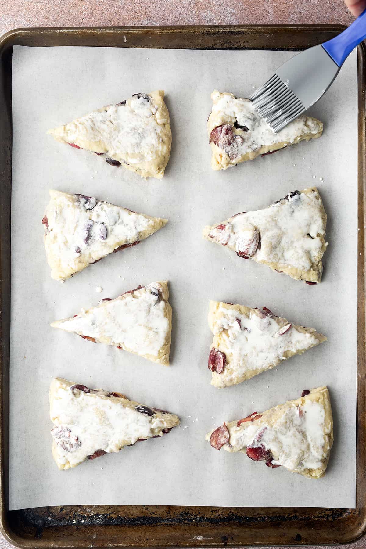 Brushing cream on scones