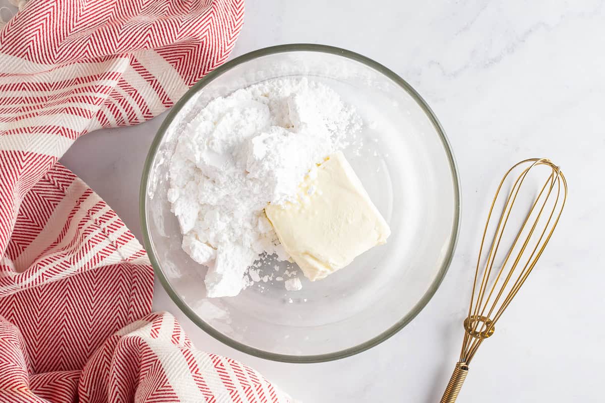 Cream cheese and powdered sugar in a mixer before being mixed