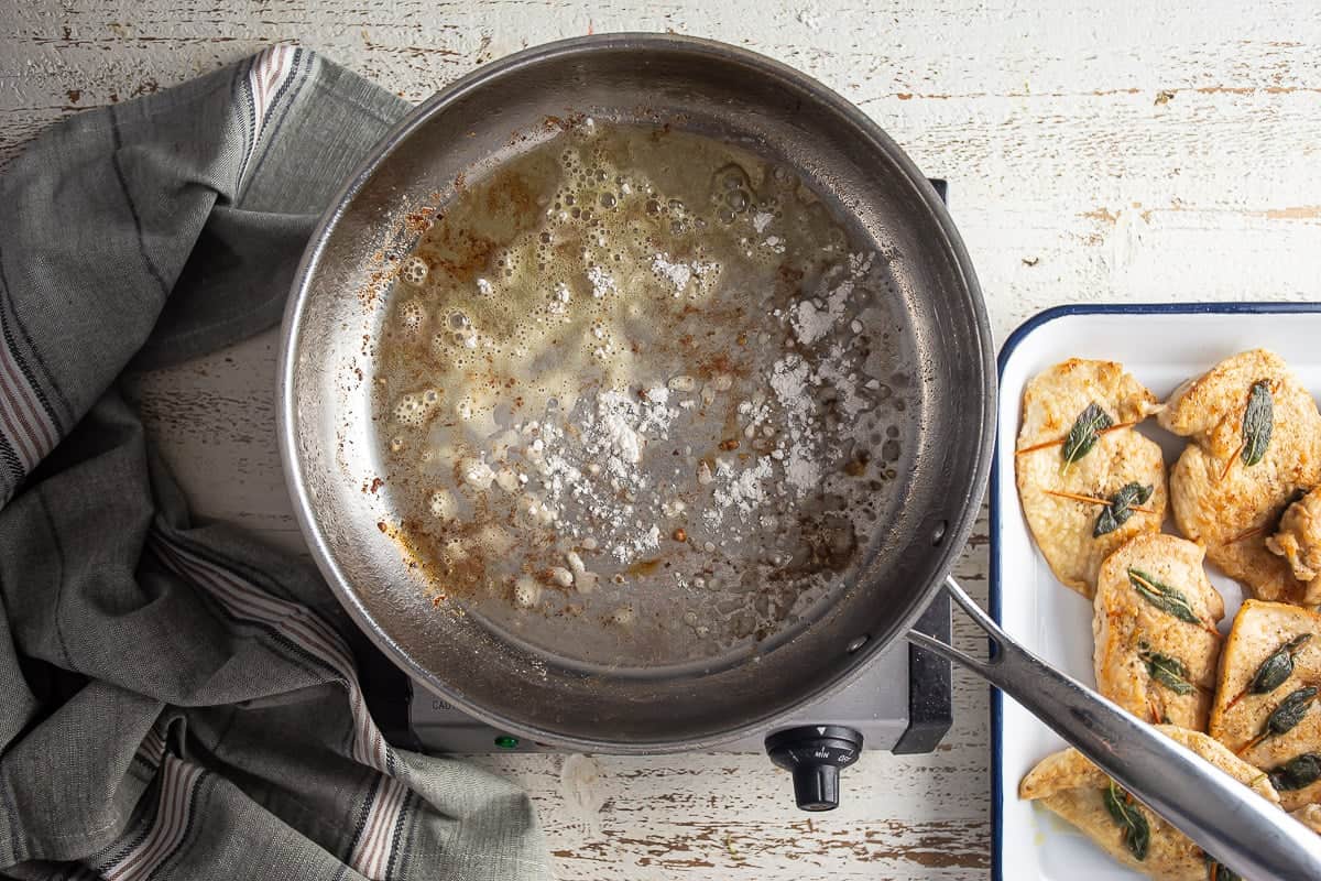 Adding flour to the pan drippings for chicken saltimbocca.