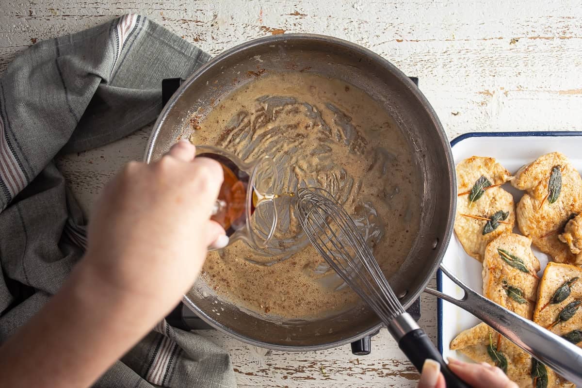 Adding wine to the roux in the stainless skillet.