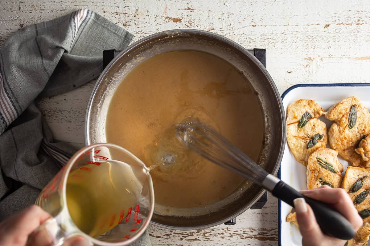 Adding chicken stock to the sauce for chicken saltimbocca.