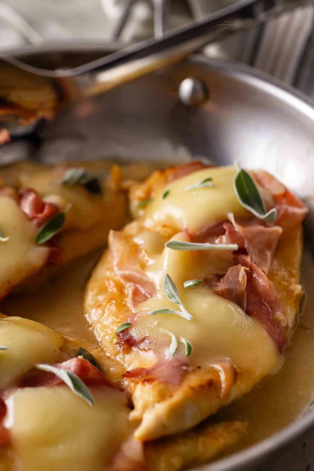 Chicken saltimbocca in a stainless steel skillet.