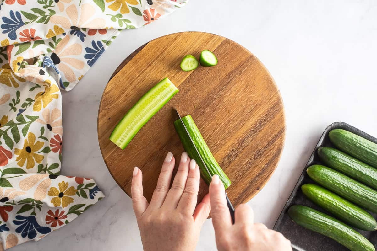 Cutting cucumbers to prep for dill pickles.